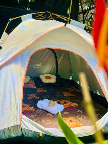 a white tent with a bed in it at Chill Door Homestay in Ấp Long Ðại