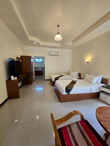 เตียงในห้องที่ OYA International Resort Phuket 普吉岛欧雅国际度假酒店