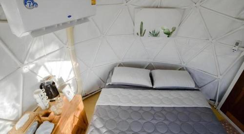 a small room with a bed in a wall tent at Nornnadubua in Uthai Thani