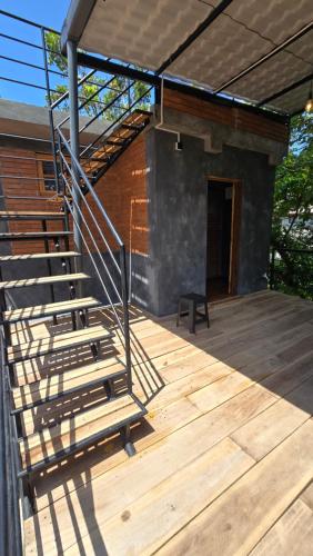 a wooden deck with a staircase on a house at Bappa's Place in Hiriketiya