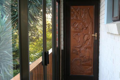 a wooden door with an entrance to a house at Dungbeetle River Lodge in Colchester