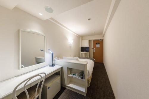 a hotel room with a bed and a mirror at Shinagawa Prince Hotel East Tower in Tokyo