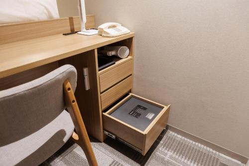 a room with a desk and a drawer with a box at Shinagawa Prince Hotel East Tower in Tokyo