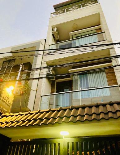a tall building with a window and a roof at Dorm bed in center with balcony, rooftop and floating market tour by ADORA in Can Tho