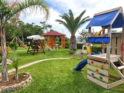 a park with a playground with a slide and swings at Le Casette Sul Mare in Capo Vaticano