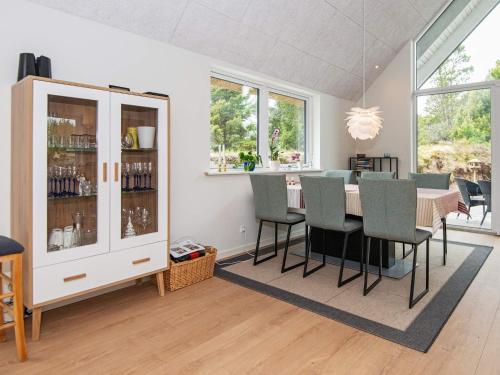 a dining room with a table and chairs at 6 person holiday home in Rømø-By Traum in Toftum
