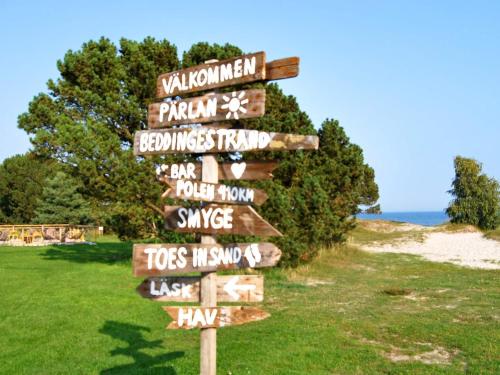 a directional sign on the side of a beach at 5 person holiday home in SMYGEHAMN in Smygehamn