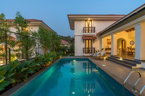 a swimming pool in the backyard of a house at Villa Asna, Villas By Noor in Aldona