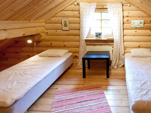 a room with two beds and a desk in a cabin at 6 person holiday home in SÄLEN-By Traum in Tandådalen