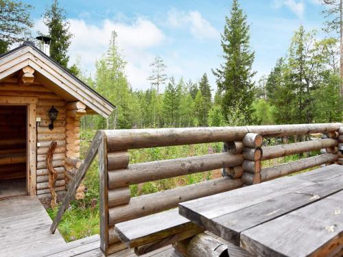 a wooden deck with a wooden bench and a cabin at 6 person holiday home in SÄLEN-By Traum in Tandådalen