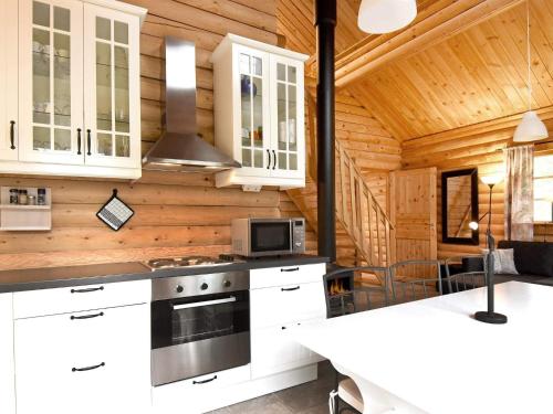 a kitchen with white cabinets and a stove at 6 person holiday home in SÄLEN-By Traum in Tandådalen