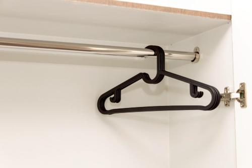 a metal towel rack hanging on a bathroom wall at Sea Inn Pattaya in Pattaya Central