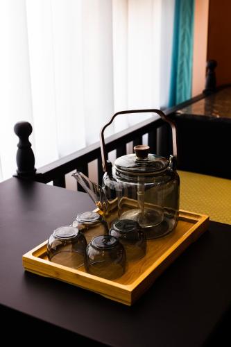 a tray with a pot and glasses on a table at Beijing Youbang Hotel in Beijing