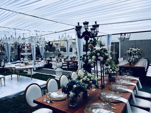 a table set up for a wedding with flowers and candles at The Peacock Mansion in Kumasi