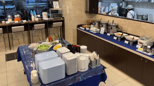 a table in a restaurant with plates of food at Toyoko Inn Nagareyama-Otakanomori Ekimae in Nagareyama