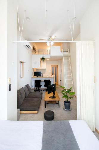 a living room with a couch and a table at STAIRS Hotel 402 in Fukuoka