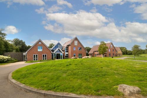 a row of brick houses on a green lawn at ESSTRA Hotel Erica in Erica