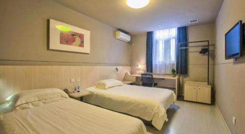 Cama o camas de una habitación en Jinjiang Inn Taizhou Huangyan Jiufeng Park