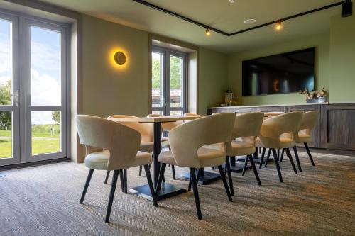a dining room with a table and chairs at ESSTRA Hotel Erica in Erica
