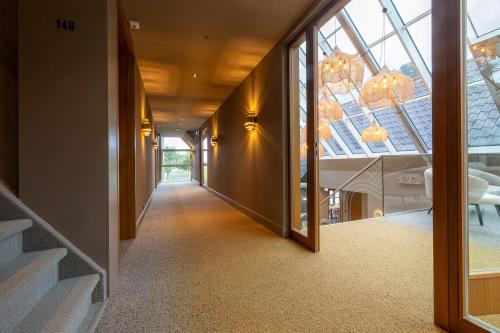 a hallway of a house with a glass ceiling at ESSTRA Hotel Erica in Erica
