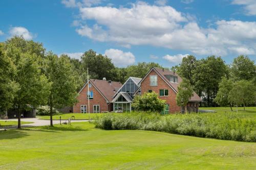 a large brick house with a green yard at ESSTRA Hotel Erica in Erica
