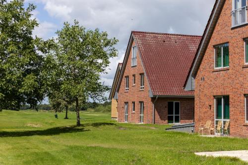an old brick building with a tree next to it at ESSTRA Hotel Erica in Erica
