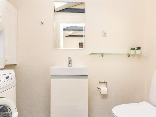 a small bathroom with a sink and a toilet at Tranquil Oasis near Golf Course-By Traum in Hals