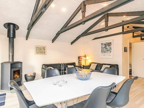 a dining room with a table and a fireplace at Tranquil Oasis near Golf Course-By Traum in Hals