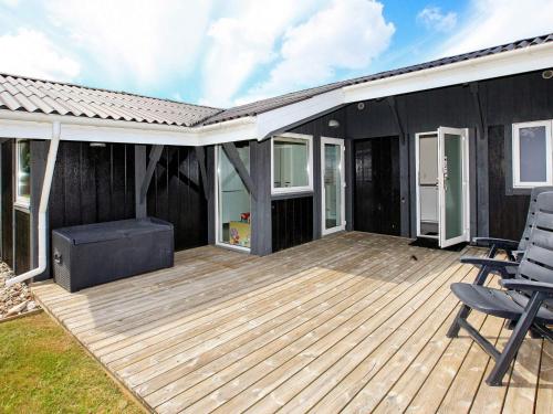 a wooden deck with chairs on a house at Tranquil Oasis near Golf Course-By Traum in Hals