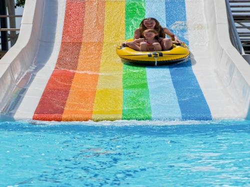a woman and a baby riding on a roller coaster at Hotel Grand Kaptan - Ultra All Inclusive in Alanya