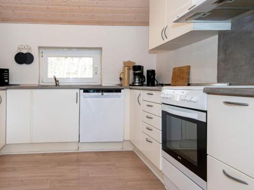 a kitchen with white appliances and a window at 8 person holiday home in Glesborg in Glesborg