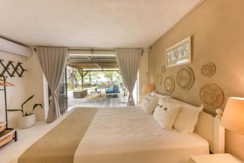 a bedroom with a large bed with white pillows at Quaint 4-bedroom Beach Villa in a fishing village in Grand Gaube