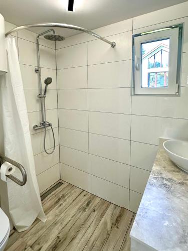 a bathroom with a shower and a sink at Bocian nad Bugiem in Mierzwice