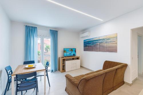 a living room with a dining room table and a couch at Home & Garden in Vico Equense