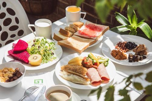 a white table with plates of food on it at Hotel G7 Taipei in Taipei