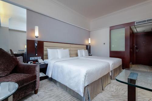 a hotel room with a large bed and a couch at Grand Sun City Hotel-Located city center Metro Access in Changsha