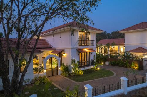 a villa with a driveway in front of a house at night at Villa Asna, Villas By Noor in Aldona