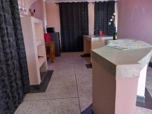 a kitchen with a sink and a counter top at Le Tai Village Homestay in Mweiga