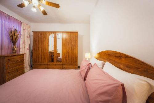 a bedroom with a large bed with a wooden headboard at Bright 3-Bed Apartment with Outdoor Dining Mellieha in Is-Sellum
