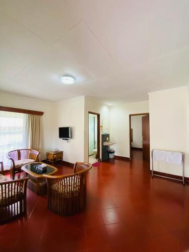 a living room with chairs and a table and a couch at Sangga Buana Resort & Convention Hotel in Pacet