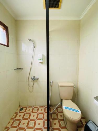 a bathroom with a toilet and a shower at Sangga Buana Resort & Convention Hotel in Pacet