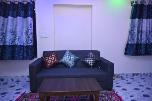 a living room with a couch and a coffee table at Sai Padma Guest House in Konārka