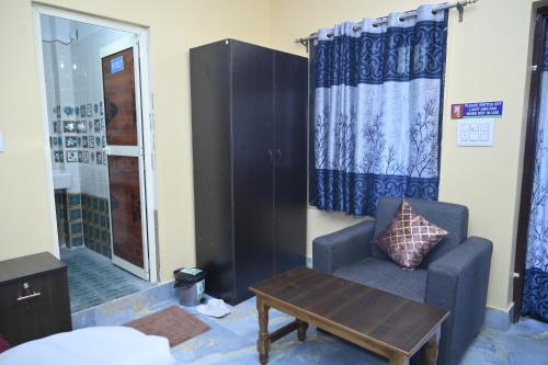 a living room with a couch and a table at Sai Padma Guest House in Konārka