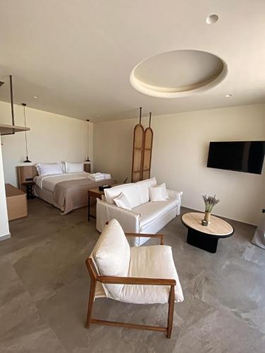 a living room with two beds and a couch at Theros Kourouta Boutique Hotel in Kourouta