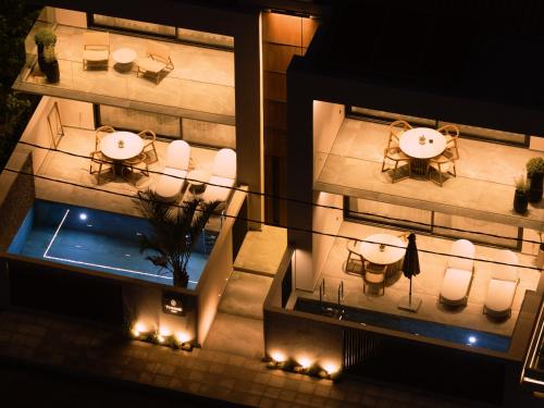 an aerial view of a building with tables and chairs at Theros Kourouta Boutique Hotel in Kourouta