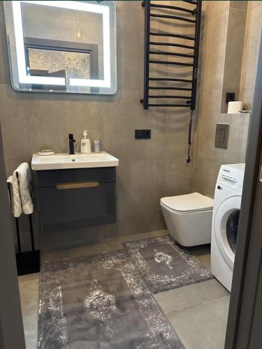 a bathroom with a sink and a washing machine at Квартира,Еврейская,1 in Bilhorod-Dnistrovskyi