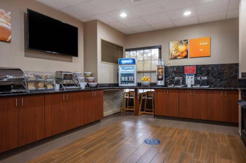 a lobby with a bar with a tv on the wall at Comfort Suites near Penn State - State College, PA in State College