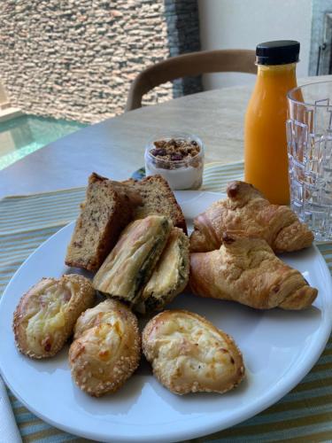 a plate of pastries and bread on a table at Theros Kourouta Boutique Hotel in Kourouta