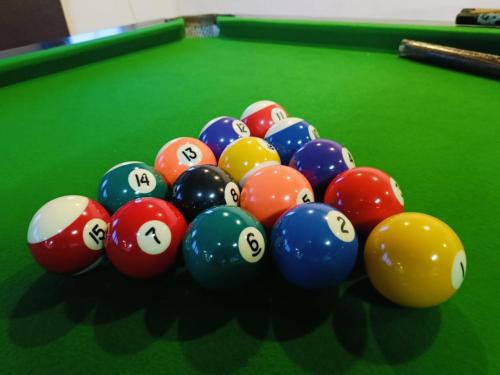 a pile of billiard balls on a pool table at Presidency Landmark in Daman