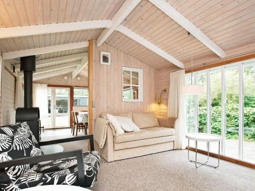 a living room with a couch and a table at 6 person holiday home in Dannemare in Dannemare